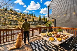 a man standing on a deck with a table of food at Pet Friendly! Elevation 25 in Park City