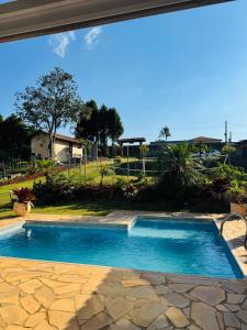 a swimming pool in the middle of a yard at Cintia Barrozo Nunes in Ibiúna