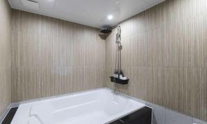 a bathroom with a bath tub and a shower at JECHEON No 25 HOTEL in Jecheon +45 photos