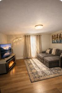 a bedroom with a bed and a television and a fireplace at Moonlight Suite in Riverview
