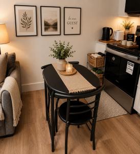 a small black table in a kitchen with a couch at Moonlight Suite in Riverview +11 photos