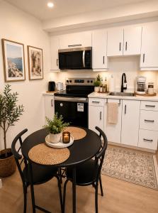 a kitchen with a table and chairs in a room at Moonlight Suite in Riverview