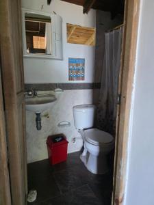 a bathroom with a toilet and a sink at Ecolodge SOY NUQUI in Nuquí