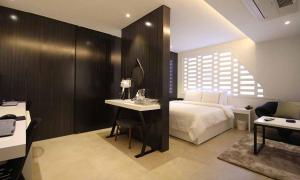 a bedroom with a bed and a desk with a mirror at Jeonju Mari Hotel in Jeonju +16 photos