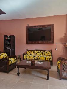 a living room with a couch and a tv at Casa Sofia in Meknès