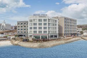 a hotel building next to a body of water at Dangjin Hotel IVAN in Dangjin
