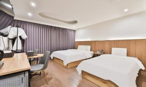 a hotel room with two beds and a tv at Beyond Hotel in Incheon +38 photos