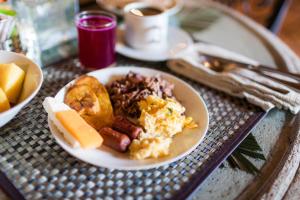 a plate of breakfast food on a table at Los Robles Charming Colonial Boutique Hotel in Managua