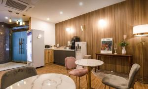 a room with a kitchen and a table and chairs at Beyond Hotel in Incheon