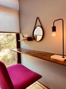 a room with a mirror and a red chair at IPPONMATSU Private Villa - 宮崎の古民家一棟貸し 一本松 in Miyazaki