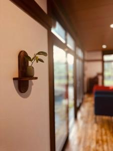 a plant on a shelf on a wall in a hallway at IPPONMATSU Private Villa - 宮崎の古民家一棟貸し 一本松 in Miyazaki +67 photos