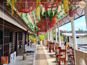a restaurant with tables and chairs and chandeliers at The Lakeview Suites in Tagaytay
