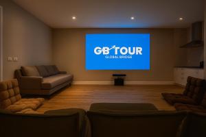 a living room with a big screen tv in a room at Emmaus Hill in Blue Haven