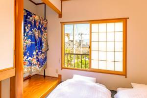 a bedroom with a large window and a bed at kagoshima take in Kagoshima