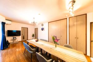 a conference room with a long wooden table and chairs at kagoshima take in Kagoshima