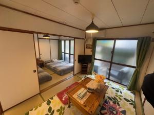 a room with a bed and a table in a room at Green Hights Residence-106 in Naha