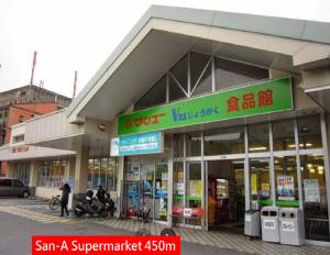 a store with a sign on the front of it at Green Hights Residence-106 in Naha