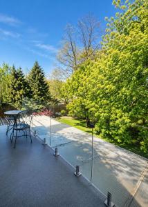 a patio with a table and some trees at Luxury Nest B&B in Niagara-on-the-Lake