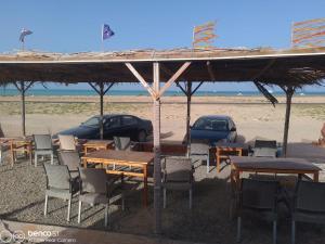 a group of tables and chairs on the beach at Hamata House Camp in Abū Ghuşūn