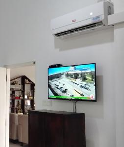 a flat screen tv hanging on a wall at Kandy Home stay - Haloluwa in Katugastota