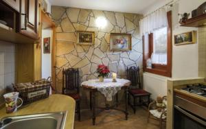 a kitchen with a small table in the middle of a room at Apartmány ReMi Vysoké Tatry in Starý Smokovec