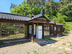 a small building with a refrigerator in front of it at Tohyang Traditional House in Bonghwa
