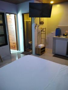 a bathroom with a sink and a toilet in a room at Nord House Laoag 7 in Laoag