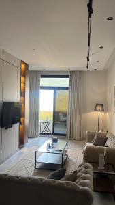 a living room with a couch and a table at Velora Suites in Abha