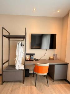 a room with a desk and a chair and a monitor at I Fly Hotel BSI in Tawau +34 photos