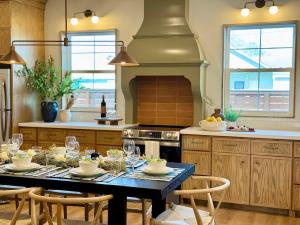 a kitchen with a table with wine glasses on it at Astra B, Designer 3BR, Arcade, Heated Pool in Port Isabel
