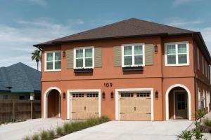 a house with a garage at Astra B, Designer 3BR, Arcade, Heated Pool in Port Isabel