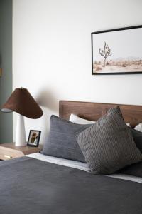 a bedroom with a bed with a lamp on a table at Astra B, Designer 3BR, Arcade, Heated Pool in Port Isabel +138 photos