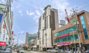 a city street with cars parked in front of buildings at Paju Geumchon Grache in Paju