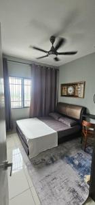 a bedroom with a bed and a ceiling fan at KP1011 Guest House in Puchong