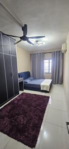 a living room with a bed and a ceiling fan at KP1011 Guest House in Puchong
