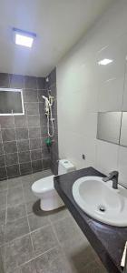 a bathroom with a sink and a toilet at KP1011 Guest House in Puchong