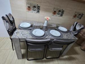 a dining table with four chairs and a tableasteryasteryasteryasteryasteryasteryastery at Bogdan my sun in Galaţi