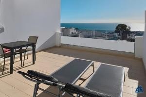 a balcony with a table and chairs and a view of the ocean at Arthouse Sea View - Acquamarina e Zaffiro in Puerto del Carmen