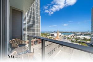 a balcony with chairs and a view of the city at Walking Distance from Bayside Market Place - 501 First Residences Junior Studio Rooftop Pool in Miami