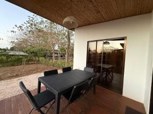 a black table and chairs on a patio at Avellanas Tiny Villa 1BR Private Self check in in Santa Cruz