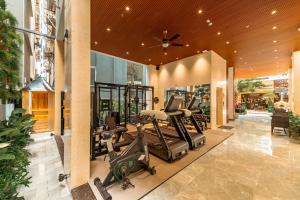 a gym with treadmills and ellipticals in a building at My Khe Hotel in Danang