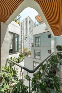 a balcony with plants and a building at My Khe Hotel in Danang