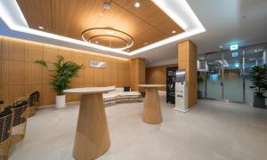 an office lobby with two tables and benches at The hound hotel bandalseom2 in Ansan