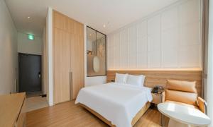 a bedroom with a white bed and a sink at The hound hotel bandalseom2 in Ansan +53 photos