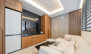 a living room with a white couch and a table at The hound hotel bandalseom2 in Ansan