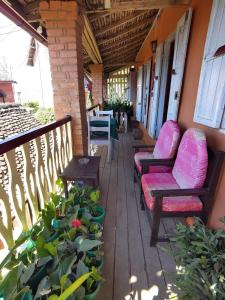 a porch with two chairs and a table at Chez Julienne in Fianarantsoa