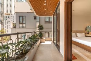 a balcony with a bed and some plants at My Khe Hotel in Danang +45 photos