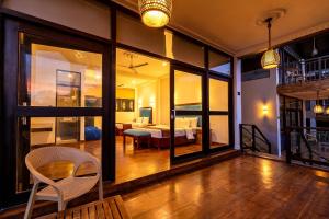 a large room with a bedroom and a bed and a table at Park Paradise in Galle