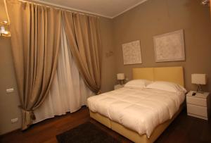 a bedroom with a large bed and a large window at Linate Residence in Segrate