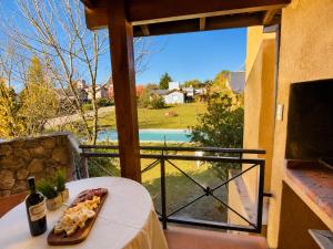 a plate of food sitting on a table on a balcony at Cabañas La Matera Apart in Los Reartes
